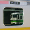 E129系の窓に映り込んだ115系電車。E129系は老朽化した115系の置換えを目的に開発された。