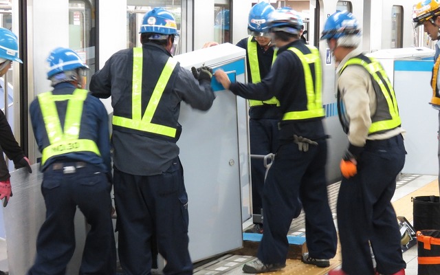 九段下駅で行われたホームドアの設置作業。500kg以上あるホームドアを数人がかりで設置していた。