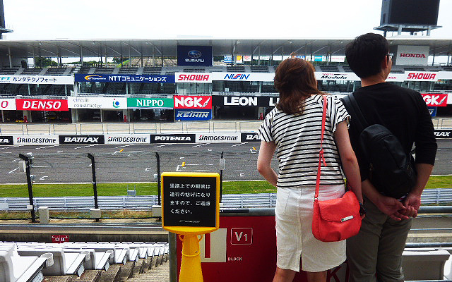鈴鹿サーキットでブライダルフェアを開催。参加したカップルたちは、国際レーシングコースやVIP席が“挙式会場”となる場面を想像しながら見学していた（三重県鈴鹿市・鈴鹿サーキット、2015年6月14日）
