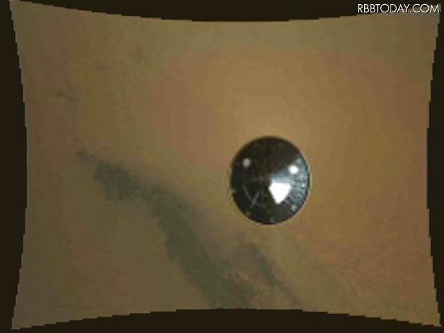 分離された降下カプセルの耐熱シールド(底蓋)。分離後約3秒、距離約16メートル。タッチダウンまであと2分半。