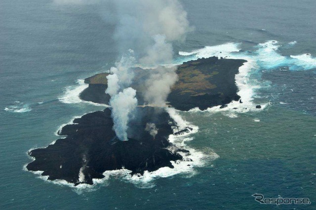 海上保安庁が2013年12月26日に撮影した西之島(奥)と新しい島(手前)。新しい島の急速な拡大で両島がつながった。