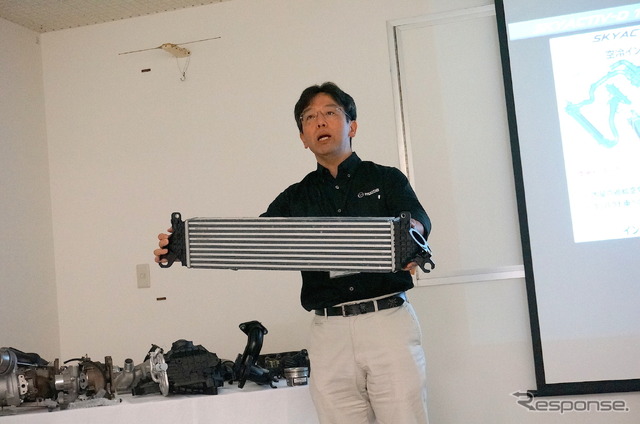 マツダ パワートレイン開発本部 新畑耕一主幹(手に持つのはSKYACTIV-D 2.2に採用している空冷式インタークーラー)