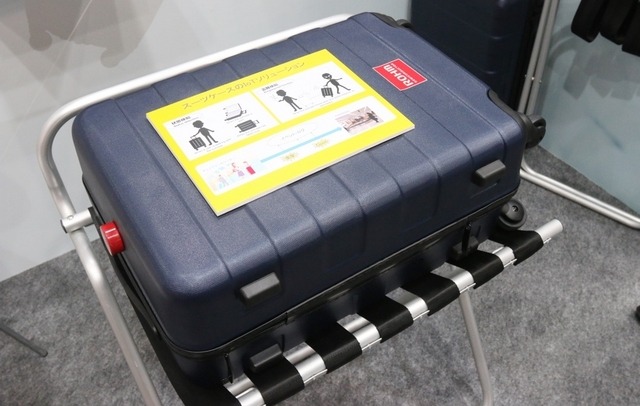 センサーメダルを設置したスーツケースのイメージ。あくまで応用例の展示なのでセンサーメダルは露出しているが、製品化する際には各メーカーが設置場所を工夫されるだろう(撮影:防犯システム取材班)