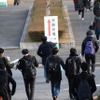 千葉県千葉大学西千葉地区試験場の正門をくぐり、受験教室へ向かう受験生たち
