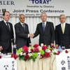 会見で握手する両社首脳